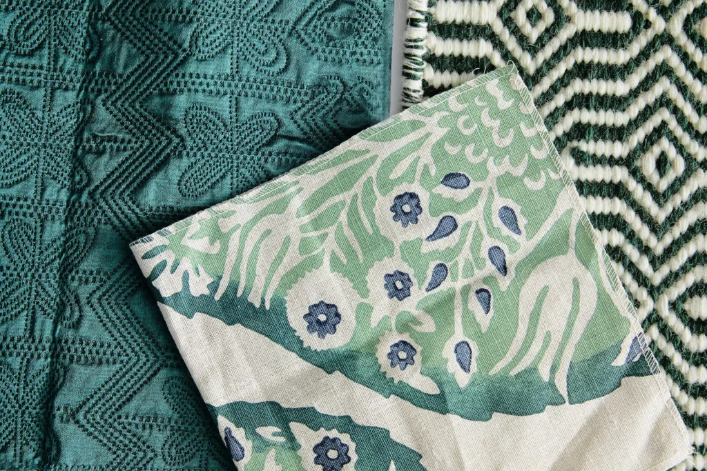 A variety of patterned and textured fabrics showing the Winter Trend Report's Color of the Season: Vining Ivy.