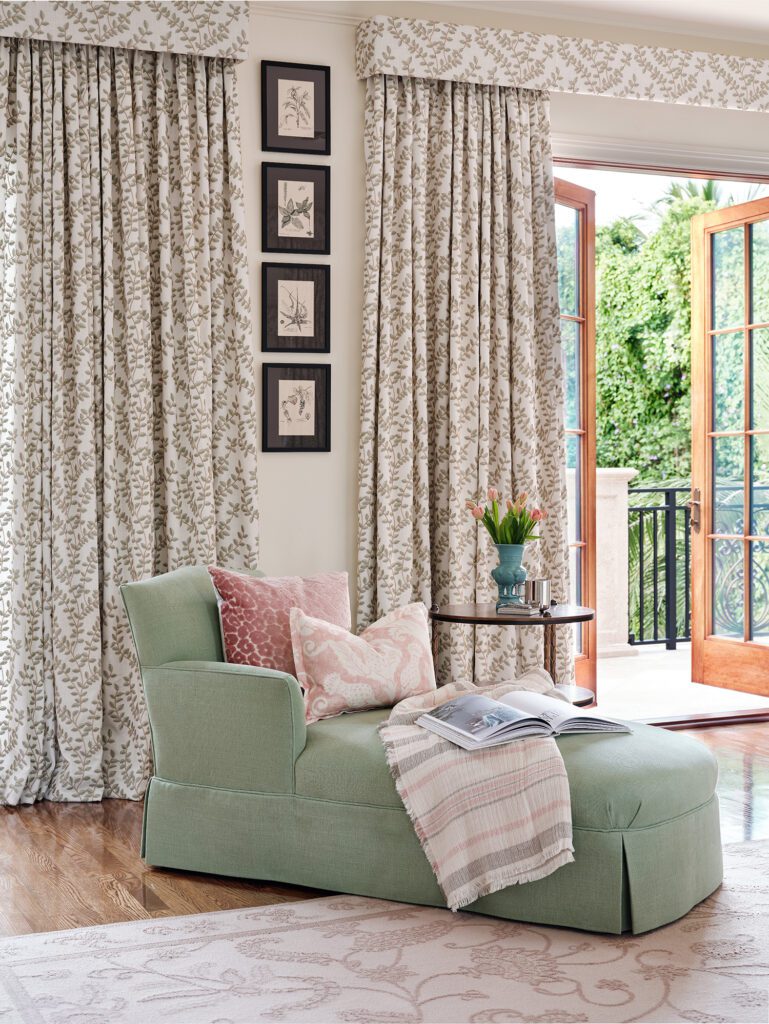2024 trends reflect in this living space. Showcasing fresh window treatments and french doors out to the terrace.